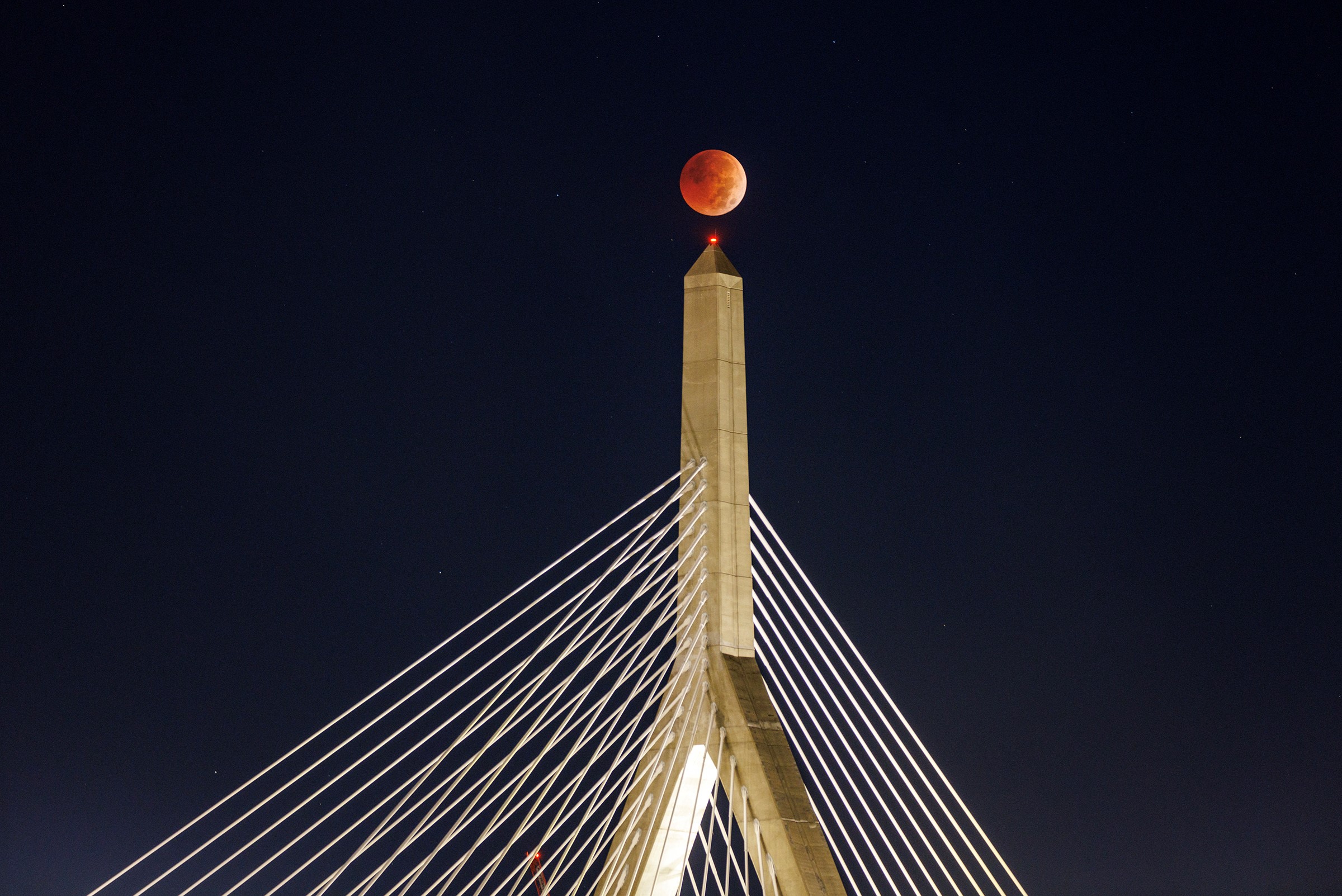 Picture shows Tuesday's lunar eclipse over the Zakim Bridge