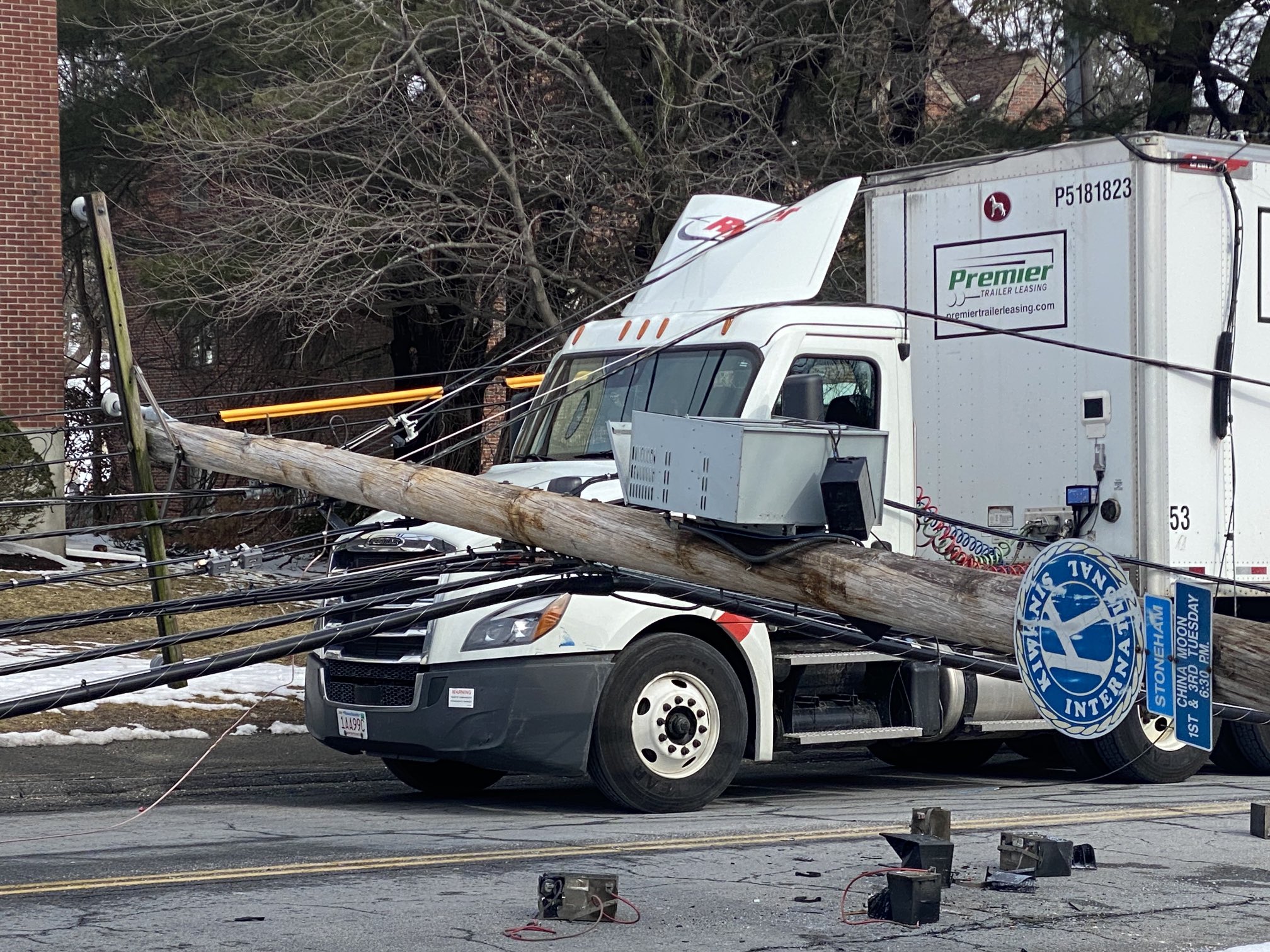 Seven utility poles carrying power liens fell along a street in Stoneham, Massachusetts, on Wednesday, March 1, 2023.