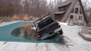 An alleged drunken driver was arrested on Monday, Jan. 13, 2020 after his truck was discovered partially submerged in a swimming pool in Scituate, Rhode Island.