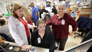 Kathleen Sheehan, left, director of Emergency and Trauma Services, speaks with Sarah Horn, center, and Lead Case Manager Jeanne Icolari in the Emergency room at St. Luke's Cornwall Hospital in Newburgh, New York, Dec. 19, 2019.