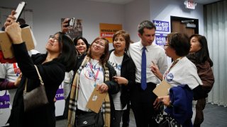 Former South Bend Mayor Pete Buttigieg meets with people at a town hall event with Asian American and Pacific Islander voters