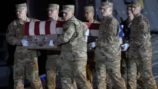 An Air Force carry team moves a transfer case containing the remains of Capt. Ryan S. Phaneuf, Thursday, Jan. 30, 2020, at Dover Air Force Base, Delaware. Phaneuf, 30, of Hudson, New Hampshire, died in a Bombardier E-11A aircraft crash in Ghazni province, Afghanistan, according to the Department of Defense.