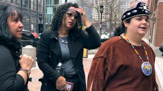 Tela Troge, right, a lawyer for the Shinnecock Indian Nation from Southampton, N.Y., speaks outside federal court Wednesday, Feb. 5, 2020, in Boston. She was in court with others, left, who came to support the Mashpee Wampanoag tribe at a hearing over land rights.