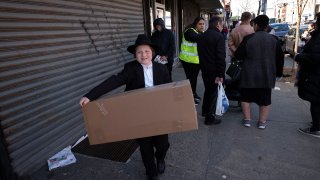 A boy carries a box of matzos for Passover that he picked up from his synagogue in the Brooklyn borough of New York.