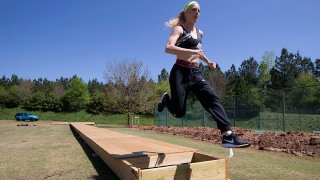 Olympic pole vaulting silver medalist Sandi Morris runs on the vaulting pit she is building with her father in Greenville, S.C., April 14, 2020.