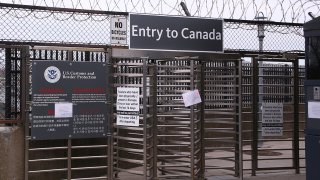 Signs hang at the entrance to Canada via the Rainbow Bridge, March 18, 2020, in Niagara Falls N.Y. President Donald Trump and Canadian Prime Minister Justin Trudeau have agreed to close the U.S.-Canada border to non-essential travel in order to slow the spread of the COVID-19 coronavirus.