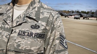 In this Thursday, June 27, 2019, file photo, a United States Air Force insignia decorates an officer's uniform near a Boeing Co. F15-E Strike Eagle combat aircraft of the 48th Fighter Wing while taking part in the joint NATO exercise ''Point Blank'' from their base at RAF Lakenheath, near Brandon, Suffolk, United Kingdom.