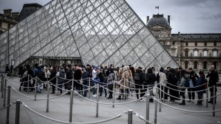 People queue at the Louvre museum.
