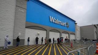 People line up outside a Walmart in New Jersey on April 18, 2020.