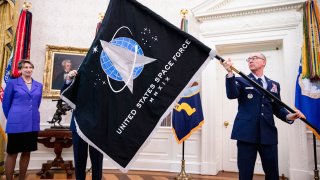 In this May 15, 2020, file photo, Chief Master Sgt. Roger Towberman (R), Space Force and Command Senior Enlisted Leader and CMSgt Roger Towberman (L), with Secretary of the Air Force Barbara Barrett present President Donald Trump with the official flag of the United States Space Force in the Oval Office of the White House in Washington, DC.