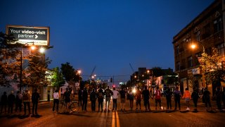 Protesters form a human chain near the 5th Police Precinct during a demonstration in Minneapolis on May 30, 2020.