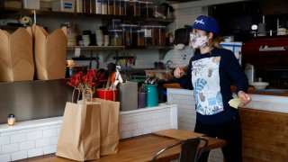 Yuka Ioroi, co-owner of Cassava restaurant on Balboa Street, manages take-out orders in San Francisco, Calif. on Wednesday, April 8, 2020.