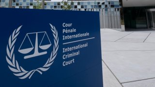 Exterior of the International Criminal Court building is seen with sign in front