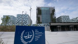 Exterior of the International Criminal Court building is seen with sign in front