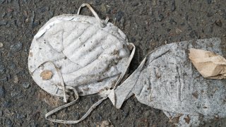 A smashed surgical mask on the street