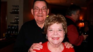 In this 2011 family photo provided by Dawn Bouska, Charles Recka and his wife, Patricia Recka, pose for a photo at a banquet in Naperville, Ill. Charles Recka died on March 12, 2020.