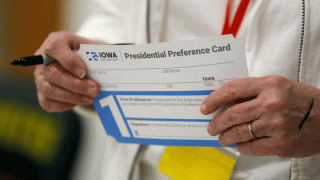A volunteer holds a Presidential Preference Card before the start of a Democratic caucus at Hoover High School, Monday, Feb. 3, 2020, in Des Moines, Iowa.