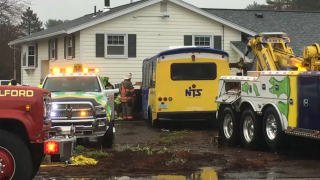 Emergency responders at the scene of a bus crash into a building in Milford, New Hampshire, on Thursday.