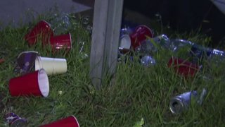 A file photo showing cups and cans on the ground.