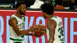 Kemba Walker #8 and Marcus Smart #36 of the Boston Celtics celebrate their 102-94 victory over the Philadelphia 76ers in Game 3 of the first round of the NBA Playoffs at The Field House at ESPN Wide World Of Sports Complex on August 21, 2020 in Lake Buena Vista, Florida.