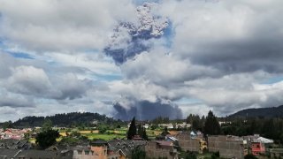 Mount Sinabung spews volcanic materials into the air as it erupts, in Karo, North Sumatra, Indonesia, Monday, Aug. 10, 2020.