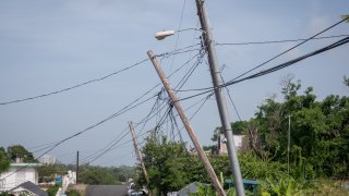 Light poles listing to the side since Hurricane Maria touched land, on September 19, 2018, in Luquillo, Puerto Rico.