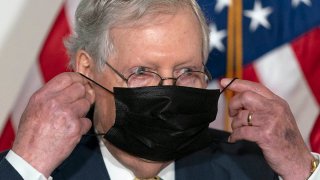 Senate Majority Leader Mitch McConnell of Ky., puts his face mask back on after speaking during a news conference of Senate Republican leadership, Sept. 9, 2020, on Capitol Hill in Washington.