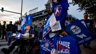 A man sells t-shirts in Wrigleyville ahead of Game Three of the 2016 World Series between the Chicago Cubs and the Cleveland Indians at Wrigley Field, Oct. 28, 2016, in Chicago.