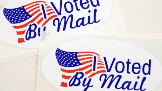 In this Sept. 4, 2020, file photo, stickers that read "I Voted By Mail" sit on a table waiting to be stuffed into envelopes by absentee ballot election workers at the Mecklenburg County Board of Elections office in Charlotte, North Carolina.