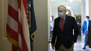 Senate Majority Leader Mitch McConnell, a Republican from Kentucky, wears a protective mask while walking to his office from the Senate Floor at the U.S. Capitol in Washington, D.C., U.S. on Tuesday, Oct. 6, 2020. House Speaker Pelosi and Treasury Secretary Mnuchin will resume negotiations today on another round of pandemic relief for the U.S. economy yet theres still no clear path to a deal before Election Day.