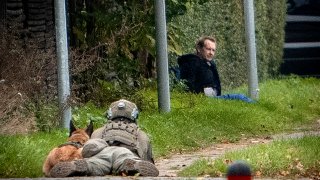 A police marksman and his dog observes convicted killer Peter Madsen threatening police with detonating a bomb while attempting to break out of jail in Albertslund, Denmark on 20 October 2020.