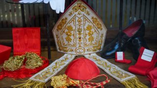 Cardinal clothing accessories are seen on display in the window of the Gammarelli clerical clothing shop, in Rome