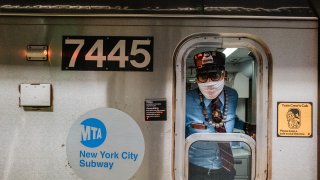 MTA subway conductor sticks his head out of the train window