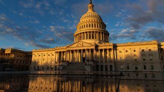 Light hits the US Capitol during sunrise in Washington, DC.