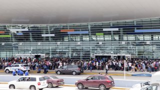 Travelers stand in line outside of Luis Muoz Marn International Airport after Hurricane Maria disrupted flight service in San Juan, Puerto Rico on Wednesday, Sept. 27, 2017. President Donald Trump said he may temporarily suspend a law that restricts the use of foreign ships operating in U.S. waters and between U.S. ports in order to accelerate the delivery of aid to Puerto Rico, where his administration faces mounting criticism over its response to Hurricane Maria.