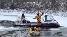 Firefighters with a hovercraft rescue a dog named Rocky from the frozen waters of a pond in Shrewsbury, Massachusetts.