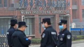 security personnel stand guard outside the Wuhan Institute of Virology in Wuhan