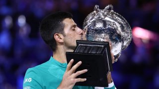 Novak Djokovic of Serbia holds the Norman Brookes Challenge Cup as he celebrates victory in his Men’s Singles Final match against Daniil Medvedev of Russia during day 14 of the 2021 Australian Open at Melbourne Park on February 21, 2021 in Melbourne, Australia.