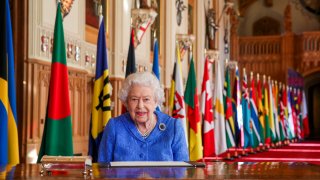 In this March 5, 2021, file photo, Britain's Queen Elizabeth II poses for a photo while signing her annual Commonwealth Day Message inside St George's Hall at Windsor Castle, England.