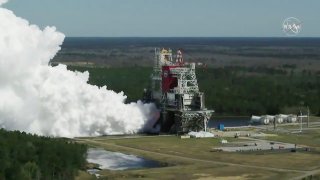 In this image from video made available by NASA, the core stage of the Space Launch System, NASA’s planned moon rocket, is tested at the Stennis Space Center near Bay St. Louis, Miss., on Thursday, Mar. 18, 2021. With this critical test finally finished, NASA now will send the rocket segment to Kennedy Space Center for launch preparations.