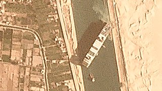 The cargo ship MV Ever Given sits wedged in the Suez Canal