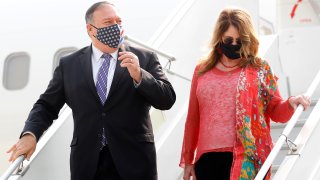 Secretary of State Mike Pompeo, and his wife Susan disembark from an aircraft upon their arrival at the airport in New Delhi, India, Monday, Oct. 26, 2020.