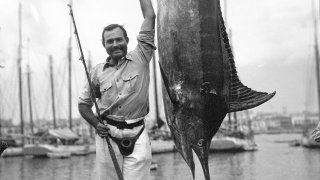 Ernest Hemingway poses with a marlin at Havana Harbor, in Key West, Fla.