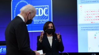 US Vice President Kamala Harris, with President Joe Biden (L), speaks to staff as she tours the Centers for Disease Control and Prevention in Atlanta, Georgia, on March 19, 2021.
