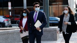 Former Fall River, Massachusetts, Mayor Jasiel Correia (center) arrives to the John Joseph Moakley United States Courthouse in Boston on Monday, April 26, 2021, when opening statements in Correia's federal corruption trial began.