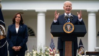Vice President Kamala Harris listens as President Joe Biden speaks on updated guidance on mask mandates, in the Rose Garden of the White House, Thursday, May 13, 2021, in Washington.