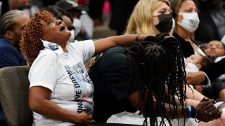 In this May 3, 2021, file photo, family members react during the funeral for Andrew Brown Jr. at Fountain of Life Church in Elizabeth City, North Carolina. Brown was fatally shot by Pasquotank County Sheriff deputies trying to serve a search warrant.