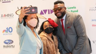 Boston Mayor Kim Janey and her daughter Kimesha take a selfie with David Ortiz at the Boston Arts Academy Honors in Norwood, Massachusetts, on Saturday, May 1, 2021.