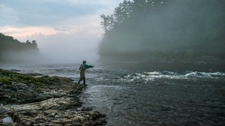 A file photo of a fly fisherman casting on the Kennebec River in Maine.