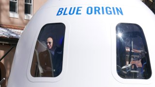 Jeff Bezos looks out of space capsule.